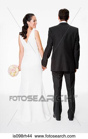 Bride and groom holding hands View Large Photo Image Picture - Bride and groom holding hands. Fotosearch