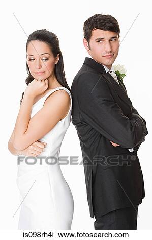 Bride and groom standing back to back View Large Photo Image Stock Image - Bride and groom standing back to back. Fotosearch