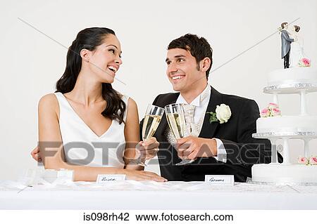 Stock Image - Bride and groom toasting with champagne. Fotosearch