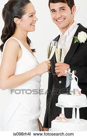 Bride and groom toasting with champagne View Large Photo Image Stock Image - Bride and groom toasting with champagne. Fotosearch