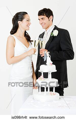 Bride and groom toasting with champagne View Large Photo Image Stock Photograph - Bride and groom toasting with champagne. Fotosearch