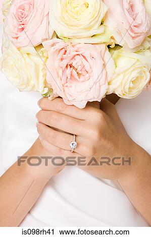 Bride holding a bouquet View Large Photo Image Stock Image - Bride holding a bouquet. Fotosearch