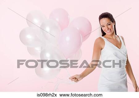 Stock Photo - Bride holding a bunch of balloons. Fotosearch