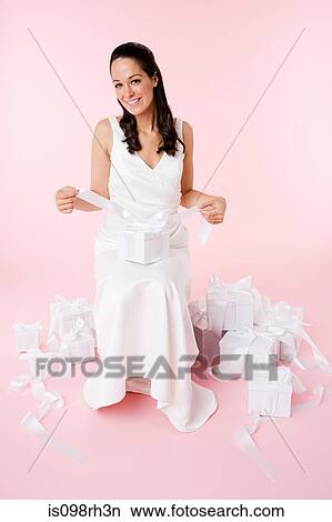 Bride sitting with wedding gifts View Large Photo Image Picture - Bride sitting with wedding gifts. Fotosearch