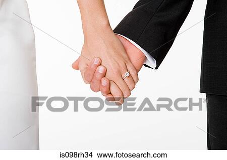 Newlywed couple holding hands View Large Photo Image Picture - Newlywed couple holding hands. Fotosearch