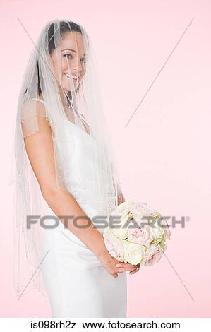 Stock Photo - Portrait of a bride holding a bouquet. Fotosearch