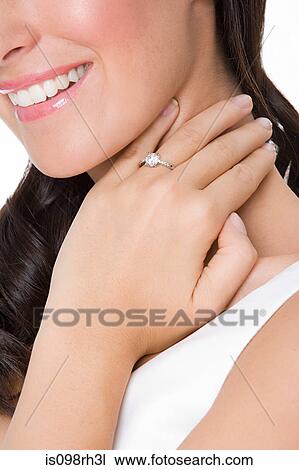 Smiling woman wearing an engagement ring View Large Photo Image Stock Image - Smiling woman wearing an engagement ring. Fotosearch
