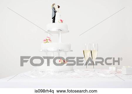 Wedding cake and champagne flutes View Large Photo Image Stock Photography - Wedding cake and champagne flutes. Fotosearch