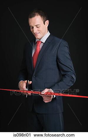 Businessman cutting a red ribbon View Large Photo Image Stock Image - Businessman cutting a red ribbon. Fotosearch