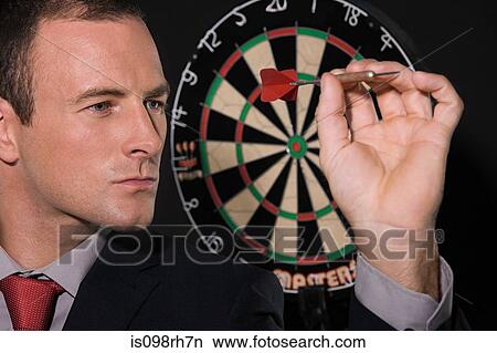 Businessman playing darts View Large Photo Image Picture - Businessman playing darts. Fotosearch