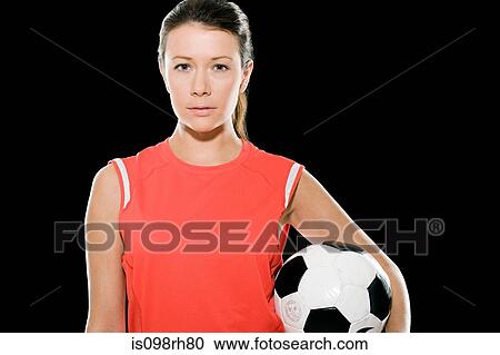 Female footballer holding a football View Large Photo Image Stock Image - Female footballer holding a football. Fotosearch