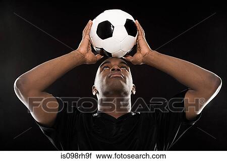 Man balancing a football on head View Large Photo Image Stock Image - Man balancing a football on head. Fotosearch