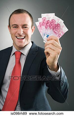 Smiling businessman with bank notes View Large Photo Image Stock Photo - Smiling businessman with bank notes. Fotosearch