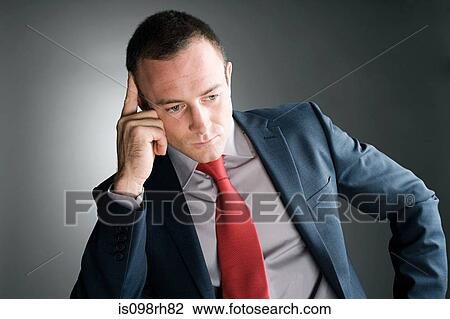 Thoughtful looking businessman View Large Photo Image Stock Image - Thoughtful looking businessman. Fotosearch