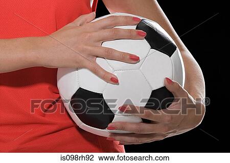 Woman holding a football View Large Photo Image Stock Image - Woman holding a football. Fotosearch