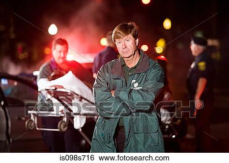 Stock Photograph - Emergency medical technician at scene of accident. Fotosearch