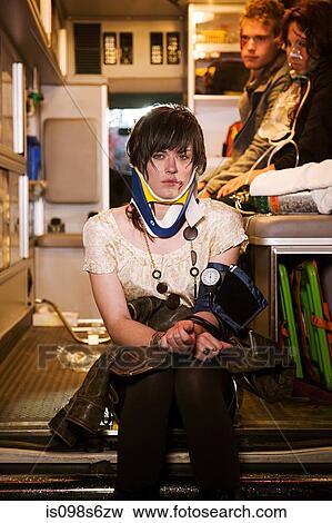 Injured young woman in an ambulance View Large Photo Image Stock Photo - Injured young woman in an ambulance. Fotosearch