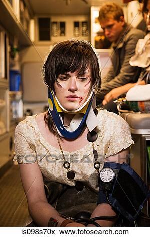 Stock Photo - Injured young woman in an ambulance. Fotosearch