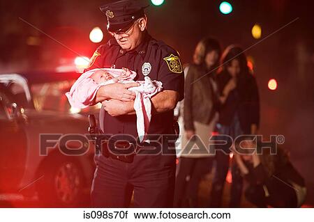 Stock Image - Police officer rescuing a baby. Fotosearch