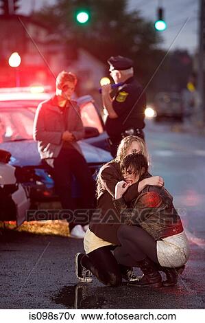 Young people and police officer at scene of car crash View Large Photo Image Stock Photo - Young people and police officer at scene of car crash. Fotosearch