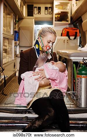 Stock Photograph - Young woman and baby in ambulance. Fotosearch