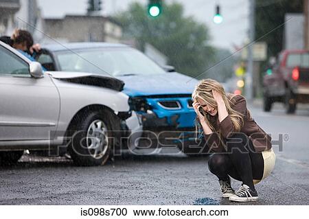 Stock Image - Young woman involved in road accident. Fotosearch
