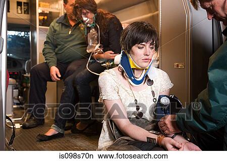 Picture - Young woman receiving medical attention. Fotosearch