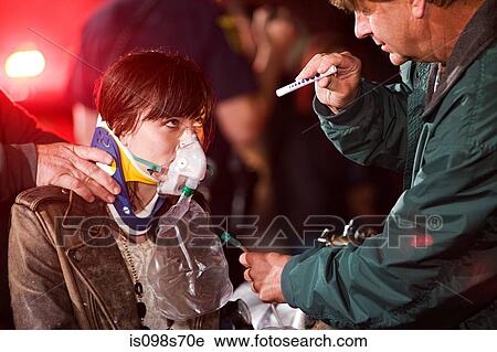 Stock Image - Young woman receiving medical attention. Fotosearch