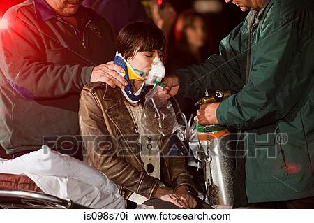 Stock Image - Young woman receiving medical attention. Fotosearch
