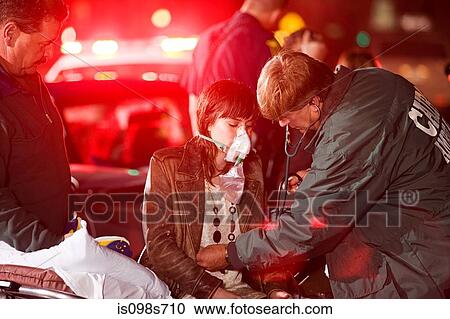 Stock Image - Young woman receiving medical attention. Fotosearch
