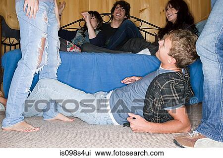 Stock Image - Friends in motel room. Fotosearch