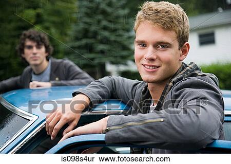Stock Photography - Two young men by car. Fotosearch