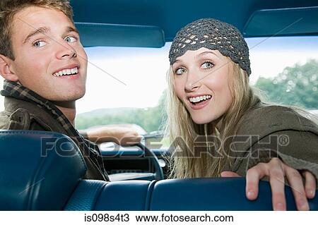 Stock Image - Young couple in car. Fotosearch