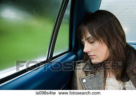 Young woman asleep in car View Large Photo Image Stock Photo - Young woman asleep in car. Fotosearch