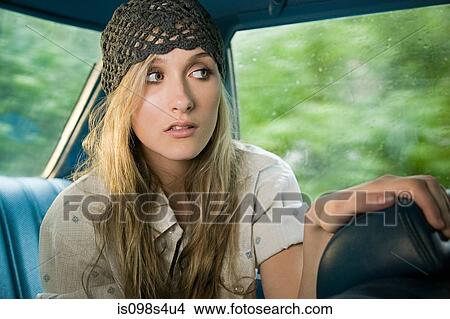 Picture - Young woman in car. Fotosearch