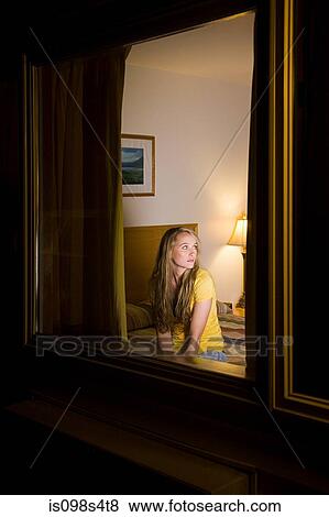 Young woman in motel room View Large Photo Image Stock Photo - Young woman in motel room. Fotosearch
