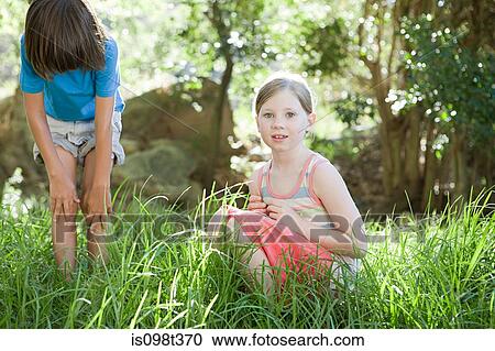 Boy and girl in grass View Large Photo Image Stock Image - Boy and girl in grass. Fotosearch