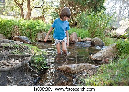 Boy in a river View Large Photo Image Stock Photo - Boy in a river. Fotosearch