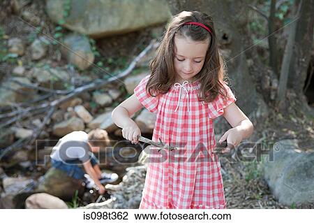 Girl holding sticks View Large Photo Image Stock Image - Girl holding sticks. Fotosearch