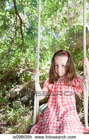 Stock Image - Girl on a swing. Fotosearch