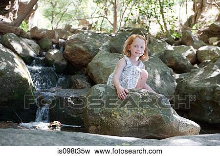 Girl on rocks by river View Large Photo Image Stock Photo - Girl on rocks by river. Fotosearch