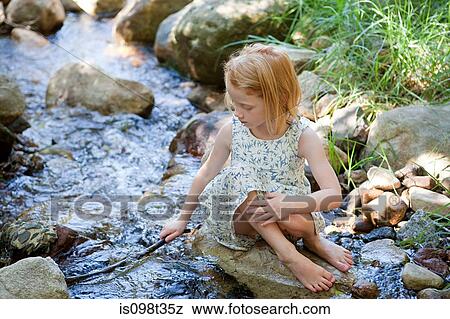Girl playing in river View Large Photo Image Stock Photo - Girl playing in river. Fotosearch