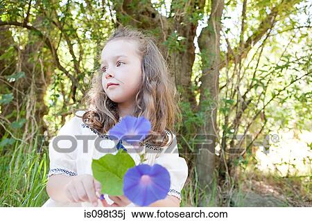 Girl with a flower View Large Photo Image Stock Image - Girl with a flower. Fotosearch