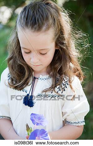 Stock Image - Girl with a flower. Fotosearch