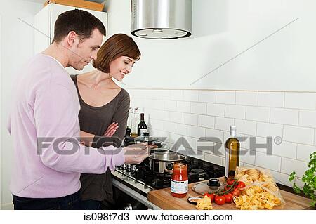 Stock Image - Couple cooking. Fotosearch