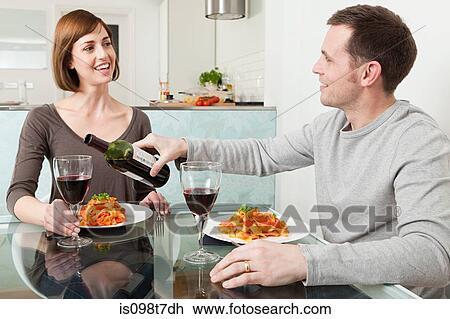 Couple having meal and wine View Large Photo Image Stock Image - Couple having meal and wine. Fotosearch