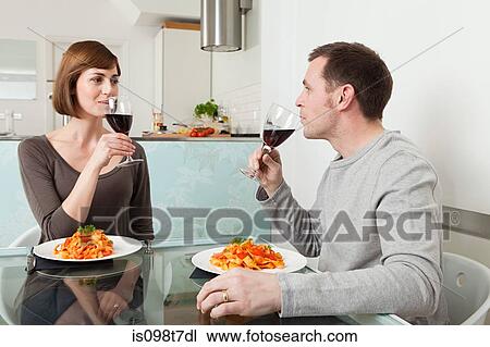 Couple having meal and wine View Large Photo Image Stock Image - Couple having meal and wine. Fotosearch