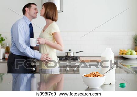Couple in kitchen at breakfast time View Large Photo Image Stock Photo - Couple in kitchen at breakfast time. Fotosearch