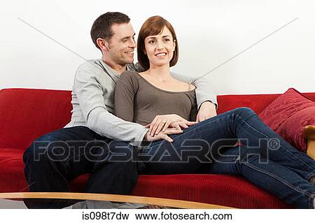Couple relaxing on sofa View Large Photo Image Stock Photo - Couple relaxing on sofa. Fotosearch