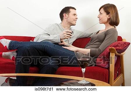 Couple relaxing with wine View Large Photo Image Stock Image - Couple relaxing with wine. Fotosearch